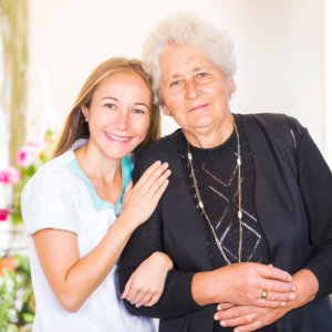 caregiver and old woman smiling