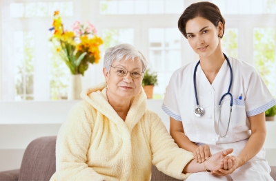 female doctor and senior woman wearing eyeglasses smiling